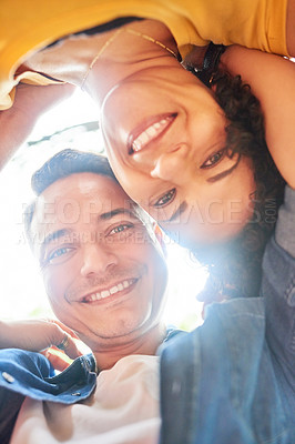 Buy stock photo Low angle portrait of an affectionate young couple standing hunched over in the park