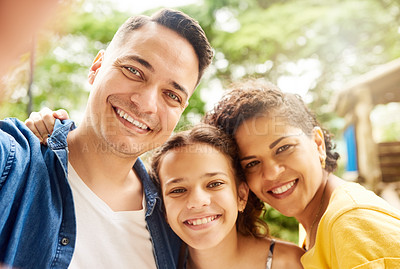Buy stock photo Cropped portrait of a young family of three taking selfies in the park