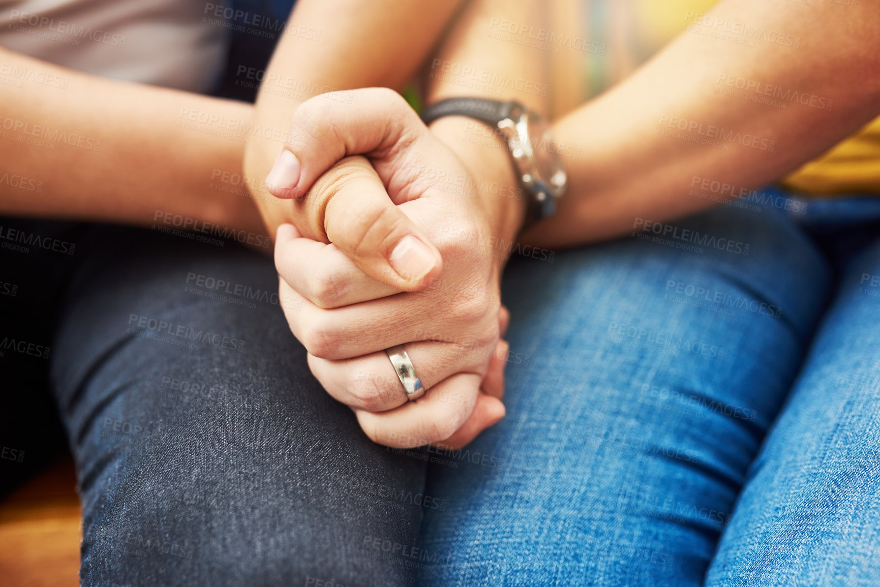 Buy stock photo Cropped shot of an unrecognizable couple holding hands tightly while sitting in the park