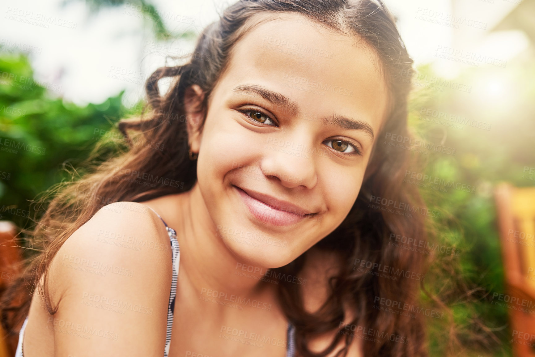 Buy stock photo Outdoor, bench and girl in portrait with smile, relax and confident during school holiday by sunshine. Backyard, female child and happy for summer on vacation, weekend adventure and pride in park