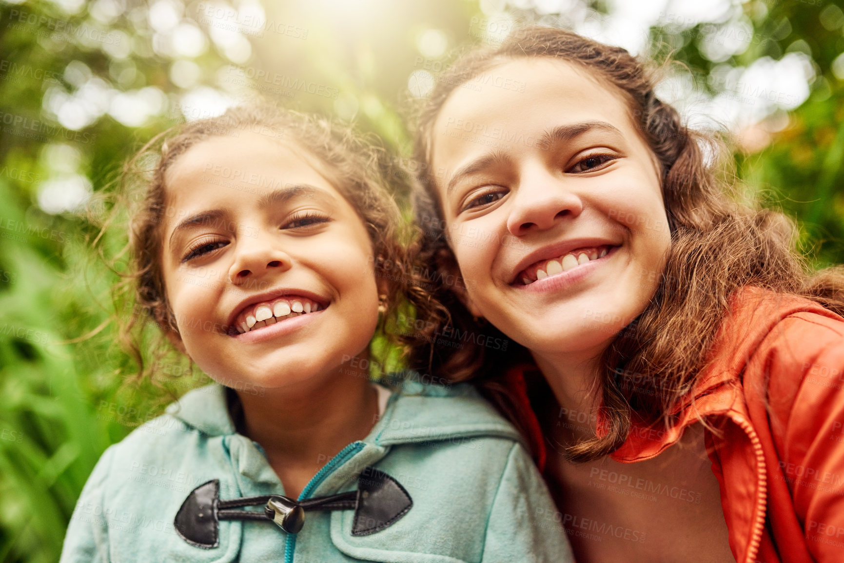 Buy stock photo Cropped portrait of two young sisters enjoying their day in the park