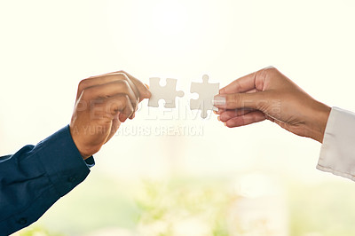 Buy stock photo Closeup shot of two unrecognizable businesspeople people joining puzzle pieces together