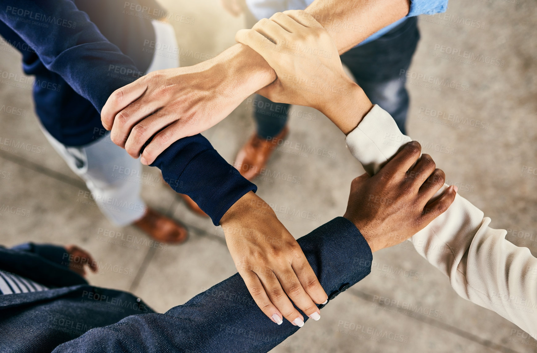Buy stock photo Closeup shot of a group of people joining their hands in a huddle 