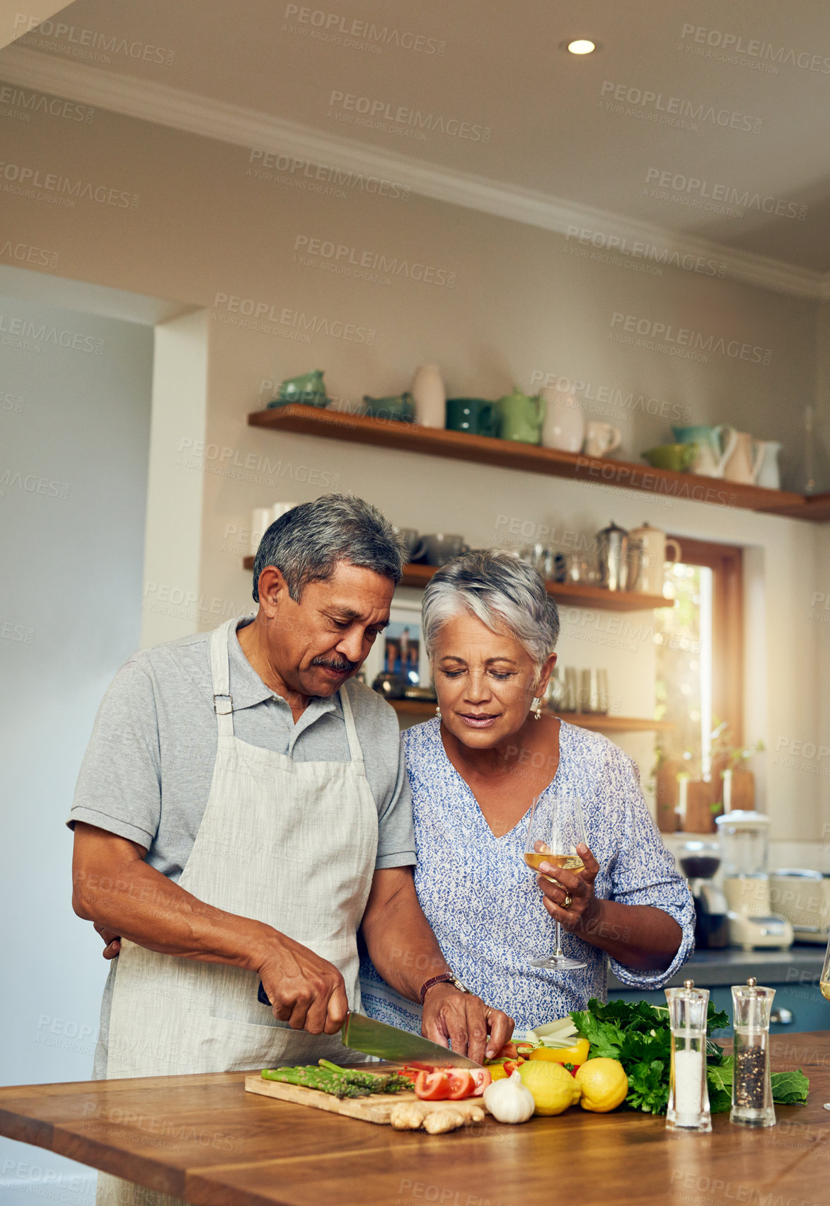 Buy stock photo Cooking, old man and woman with wine in kitchen, healthy food and marriage bonding together in home. Drink, glass and vegetables, senior couple with vegetables, meal prep and wellness in retirement.