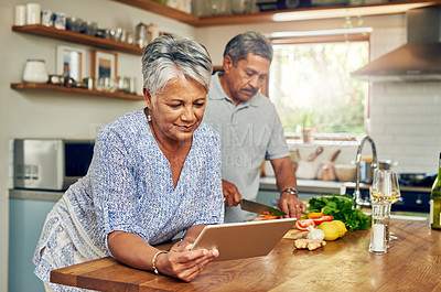 Buy stock photo Senior woman at kitchen counter with man, tablet and cooking healthy food together in home. Digital recipe, smile and old couple in house with meal prep, happiness and wellness diet in retirement.