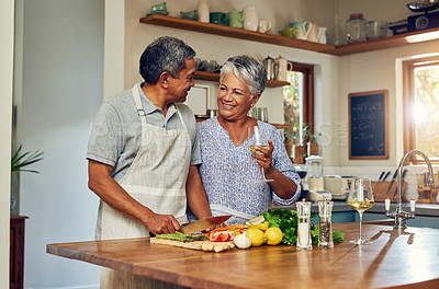 Buy stock photo Love, cooking and old couple with wine in kitchen, healthy food and marriage bonding together in home. Drink, glass and senior woman with man, meal prep and vegetables for wellness diet in retirement