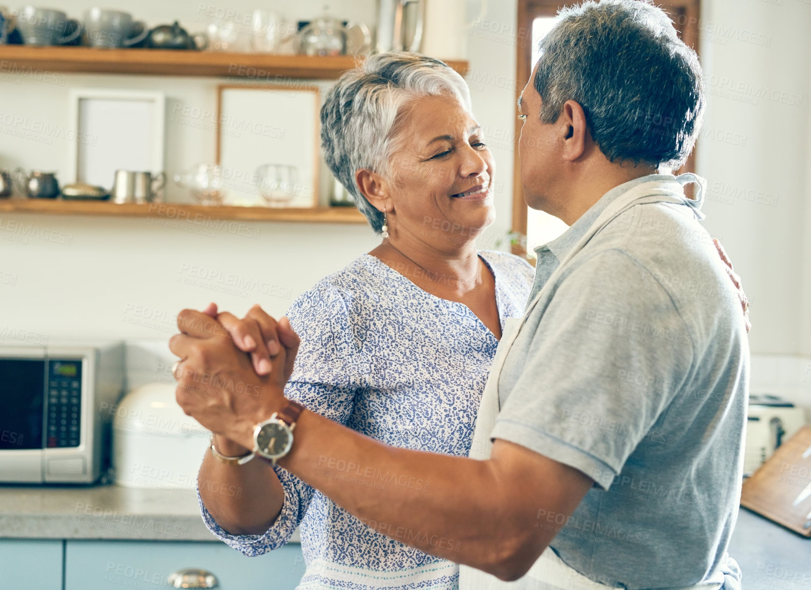 Buy stock photo Dancing, happy and senior couple in kitchen for bonding, loving relationship and romance together in home. Retirement, marriage and mature man and woman with food for cooking meal, lunch and dinner