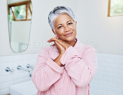 Buy stock photo Portrait of a cheerful mature woman holding her hands together while looking at the camera at home during the day