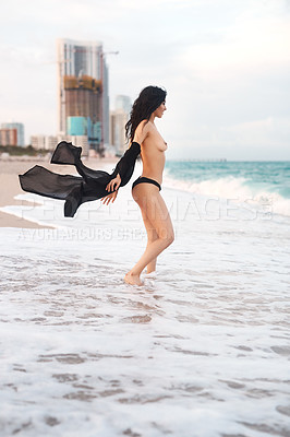 Buy stock photo Shot of a young beautiful woman in her bikini at the beach