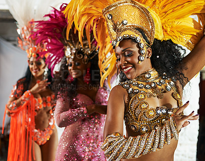 Buy stock photo Cropped shot of three beautiful samba dancers performing in a carnival with their band