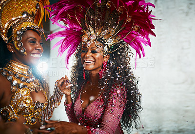 Buy stock photo Cropped shot of two beautiful samba dancers performing in a carnival with their band