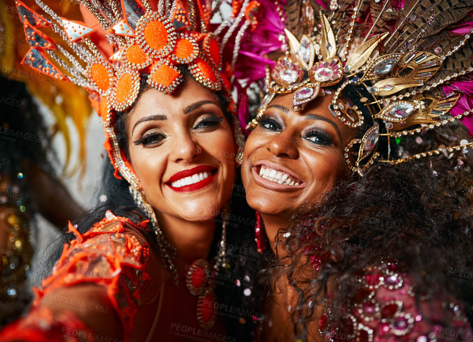 Buy stock photo Cropped portrait of two beautiful samba dancers performing in a carnival with their band