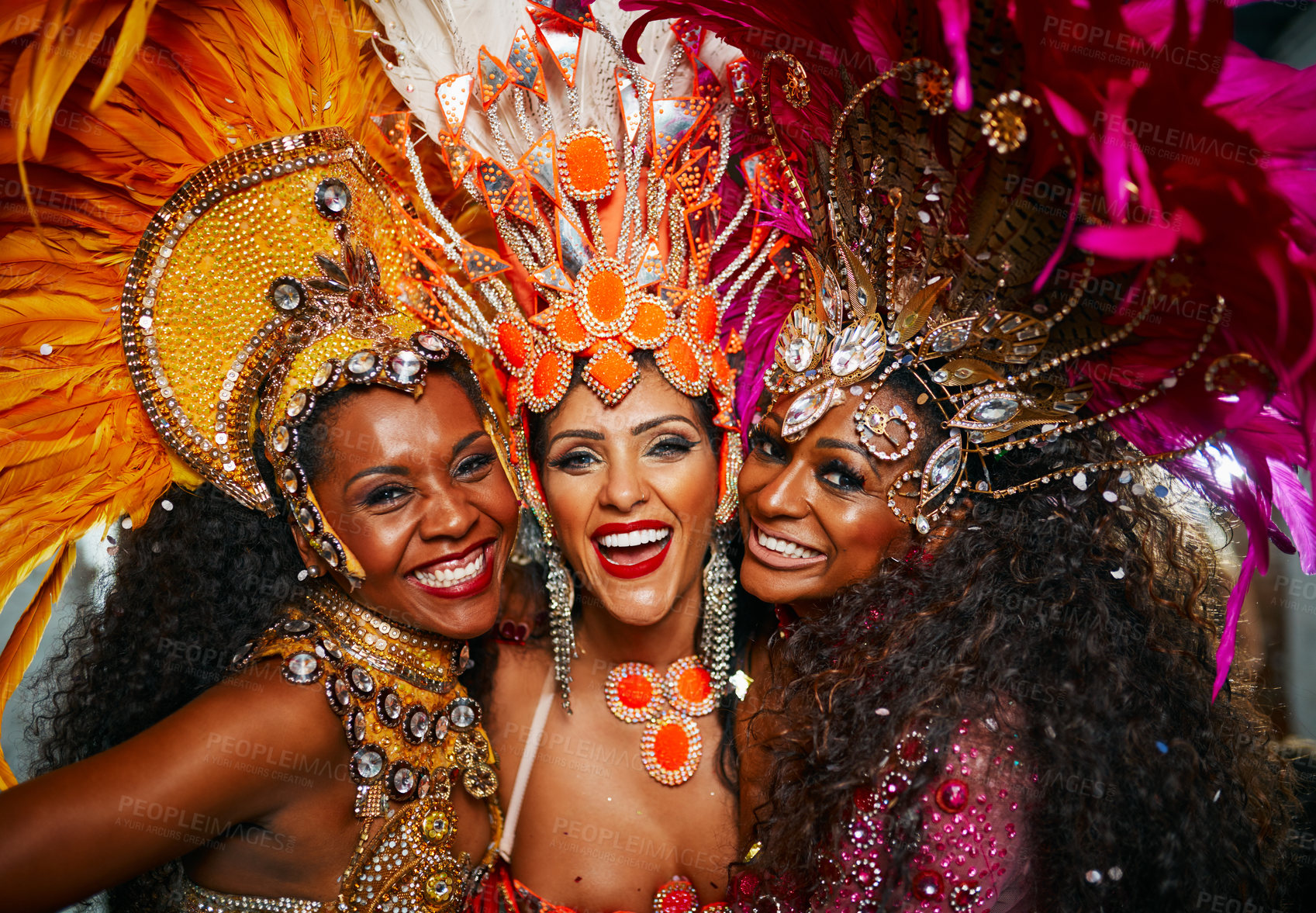 Buy stock photo Cropped portrait of three beautiful samba dancers performing in a carnival with their band