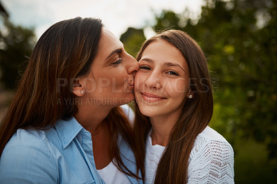 Buy stock photo Cropped shot of a young woman kissing her young daughter on the cheek