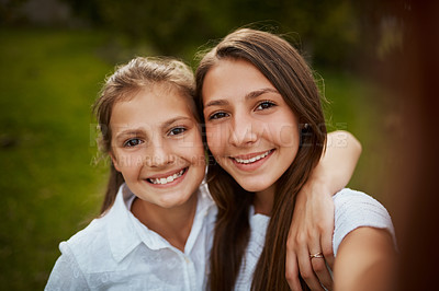 Buy stock photo Cropped portrait of two young sisters taking selfies in the park