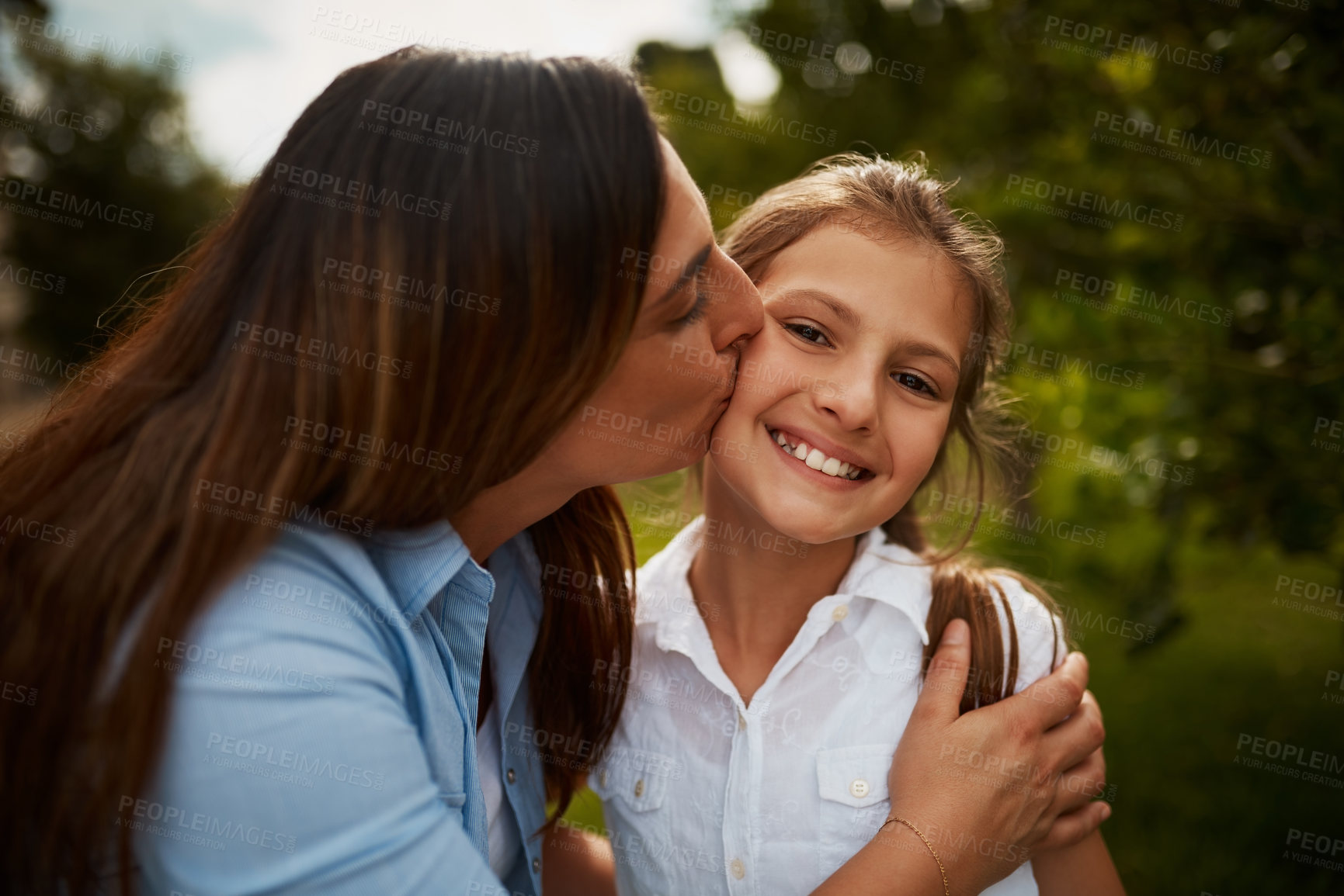 Buy stock photo Kiss, mom and happy girl in park for portrait, love or bonding together with single parent, hug or care. Kid, relax and proud mother in nature with support, daughter or teenager with smile in Sweden