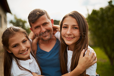 Buy stock photo Cropped shot of a handsome man and his two young daughters standing outside