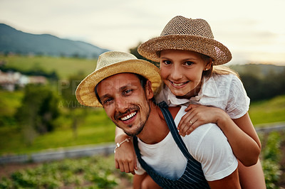 Buy stock photo Cropped portrait of a handsome man piggybacking his young daughter while working on their farm