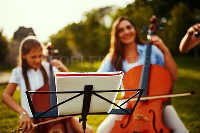 Buy stock photo Cropped shot of a beautiful mother playing instruments with her adorable daughter outdoors
