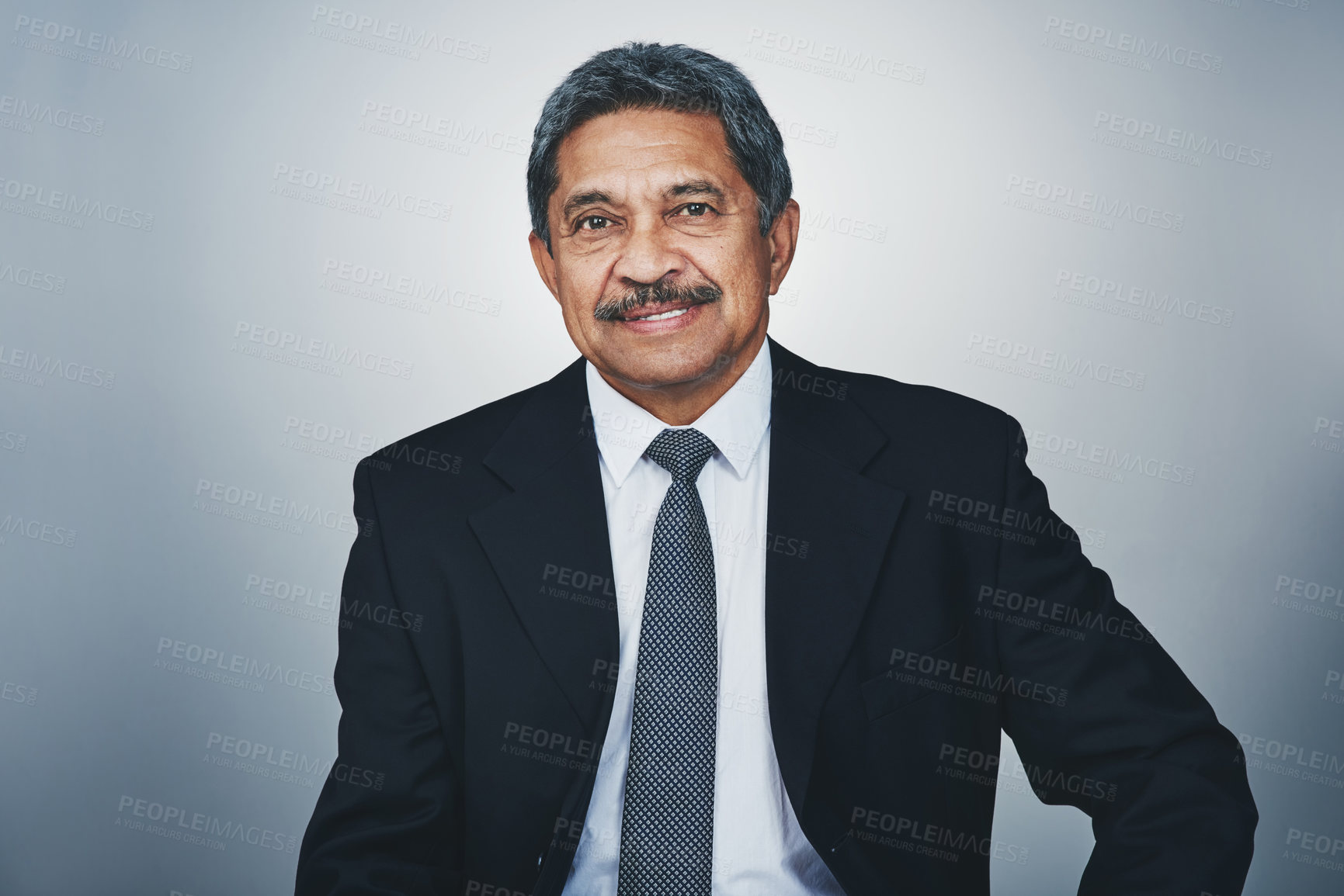 Buy stock photo Studio portrait of a mature businessman posing against a grey background