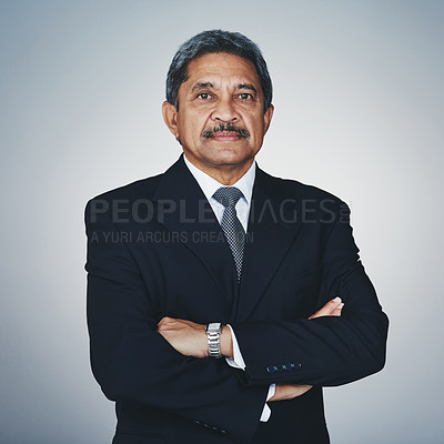 Buy stock photo Studio portrait of a mature businessman posing against a grey background