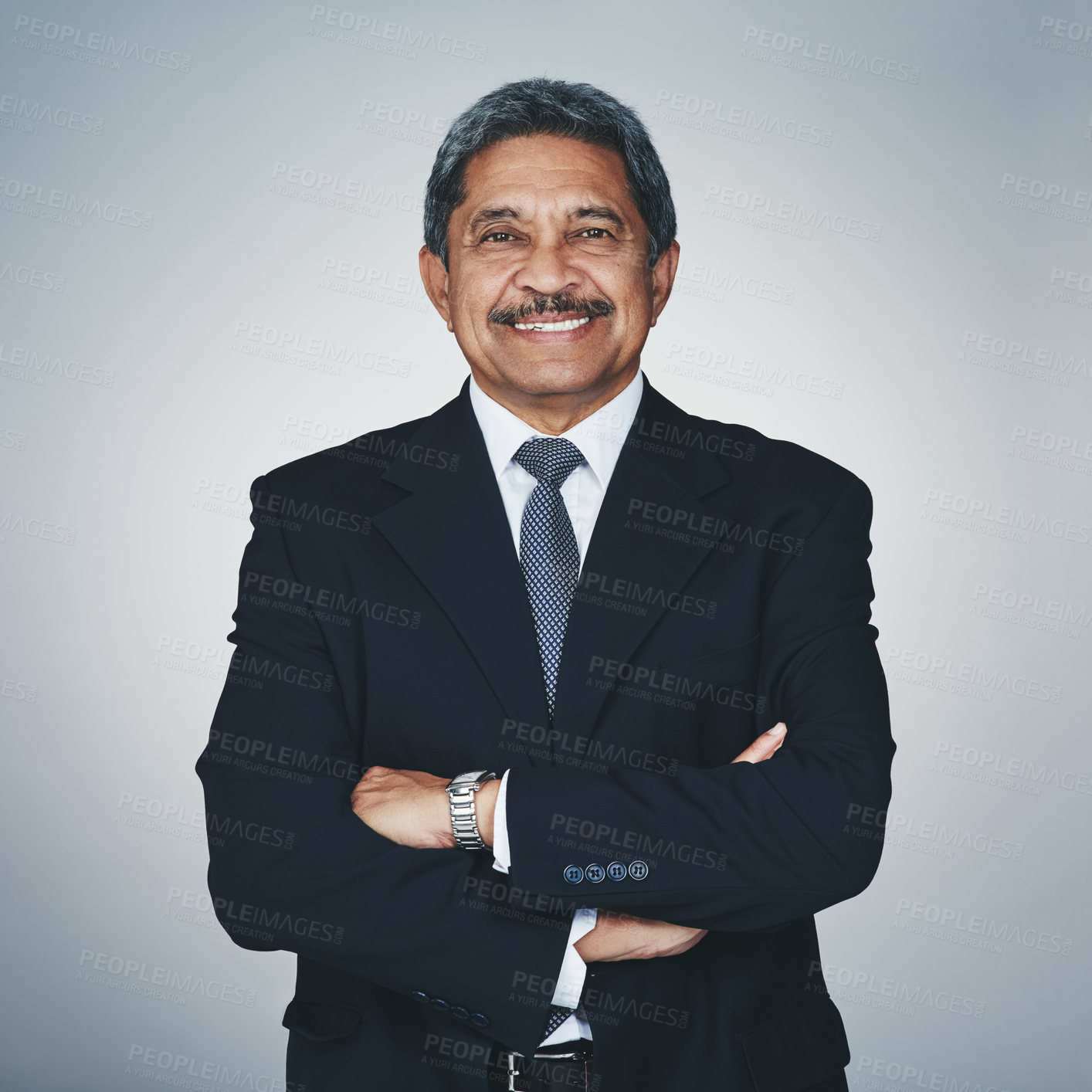 Buy stock photo Studio portrait of a mature businessman posing against a grey background