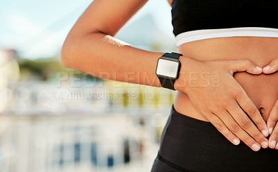 Buy stock photo Woman, hands and stomach with fitness for health, digestion or wellness with diet in city. Closeup, female person or runner with heart emoji on belly for healthy gut, exercise or training in town