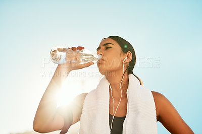 Buy stock photo Woman, fitness and drinking water with exercise outdoor for hydration, thirsty and workout break. Girl, mockup and earphones with music, radio or audio playlist for morning jog, running or lens flare