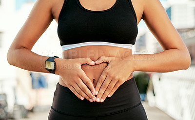 Buy stock photo Woman, hands and stomach with fitness for digestion, wellness or healthy diet in city. Closeup, female person or runner with heart emoji on belly for gut health, exercise or training in an urban town