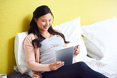 Buy stock photo Shot of a pregnant woman using a digital tablet and credit card at home