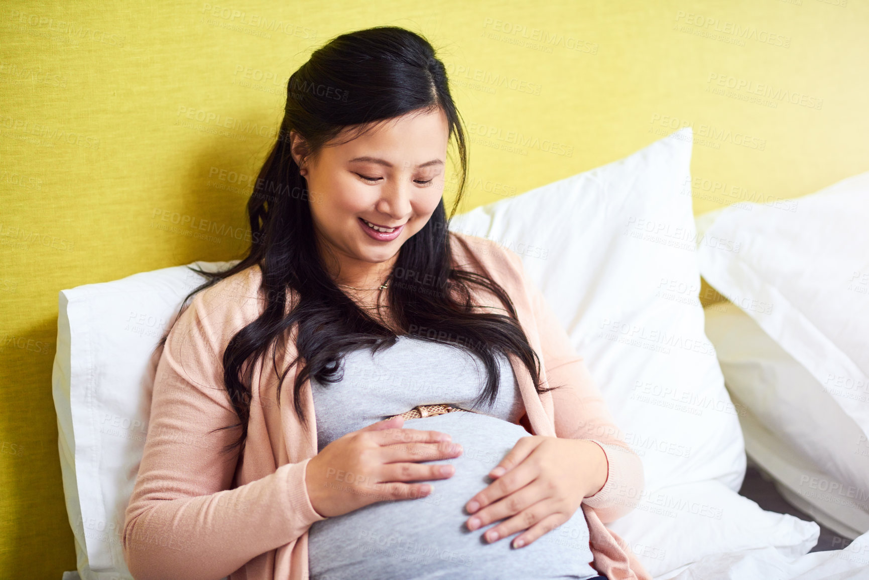 Buy stock photo Shot of a pregnant woman relaxing at home