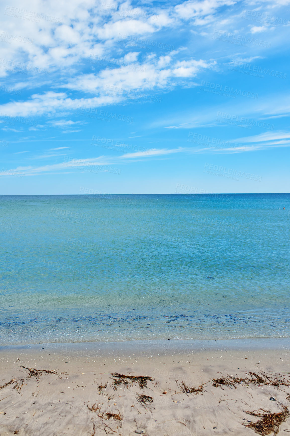 Buy stock photo Copy space at the sea with a blue sky background. Calm ocean waves at an empty beach. The scenic landscape for a relaxing summer holiday. Cloudy sky and clean water at the seashore.