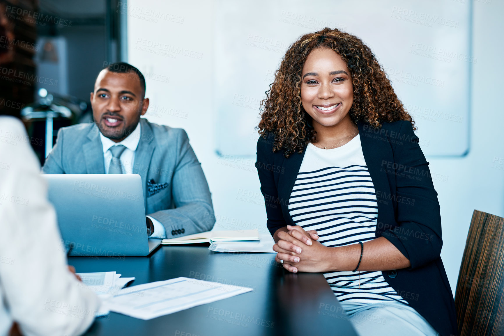Buy stock photo Cropped portrait of an attractive young businesswoman sitting amongst her colleagues during a meeting in the boardroom