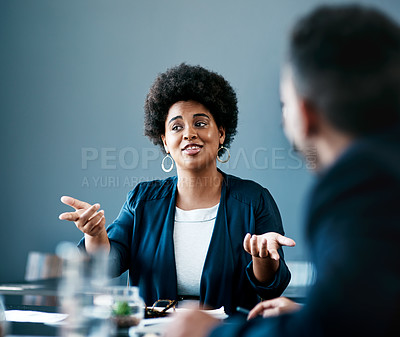 Buy stock photo Cropped shot of an attractive young businesswoman talking to her colleagues during a meeting in the boardroom