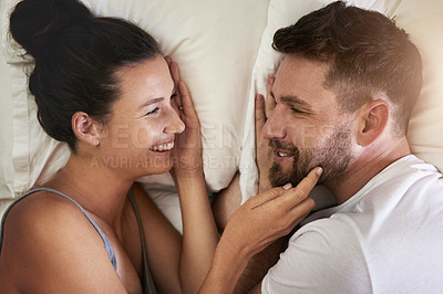 Buy stock photo Relax, marriage and smile of couple in bed from above for anniversary, honeymoon or romance together. Love, morning or weekend with happy man and woman in bedroom of apartment for conversation