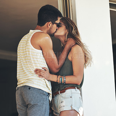 Buy stock photo Cropped shot of an affectionate young couple sharing an intimate moment outside on their balcony