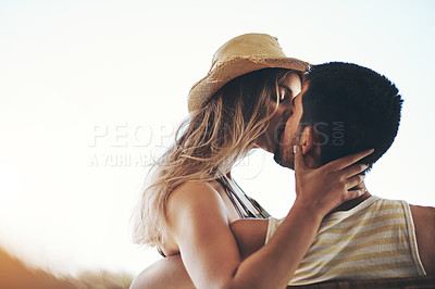 Buy stock photo Cropped shot of an affectionate young couple sharing an intimate moment outside on their balcony