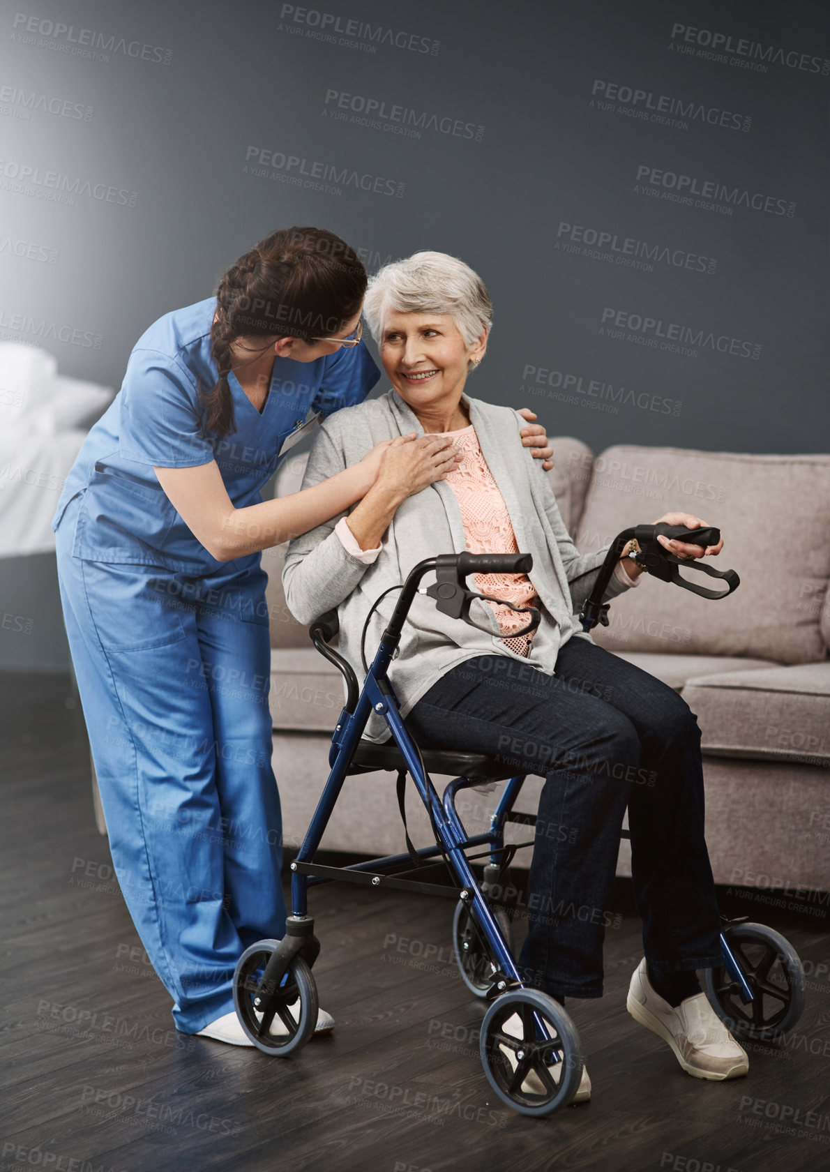 Buy stock photo Full length shot of a young female nurse talking to a wheelchair-bound senior female patient
