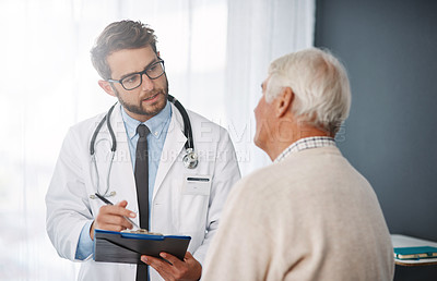 Buy stock photo Cropped shot of a young male doctor going through medical records with his senior male patient