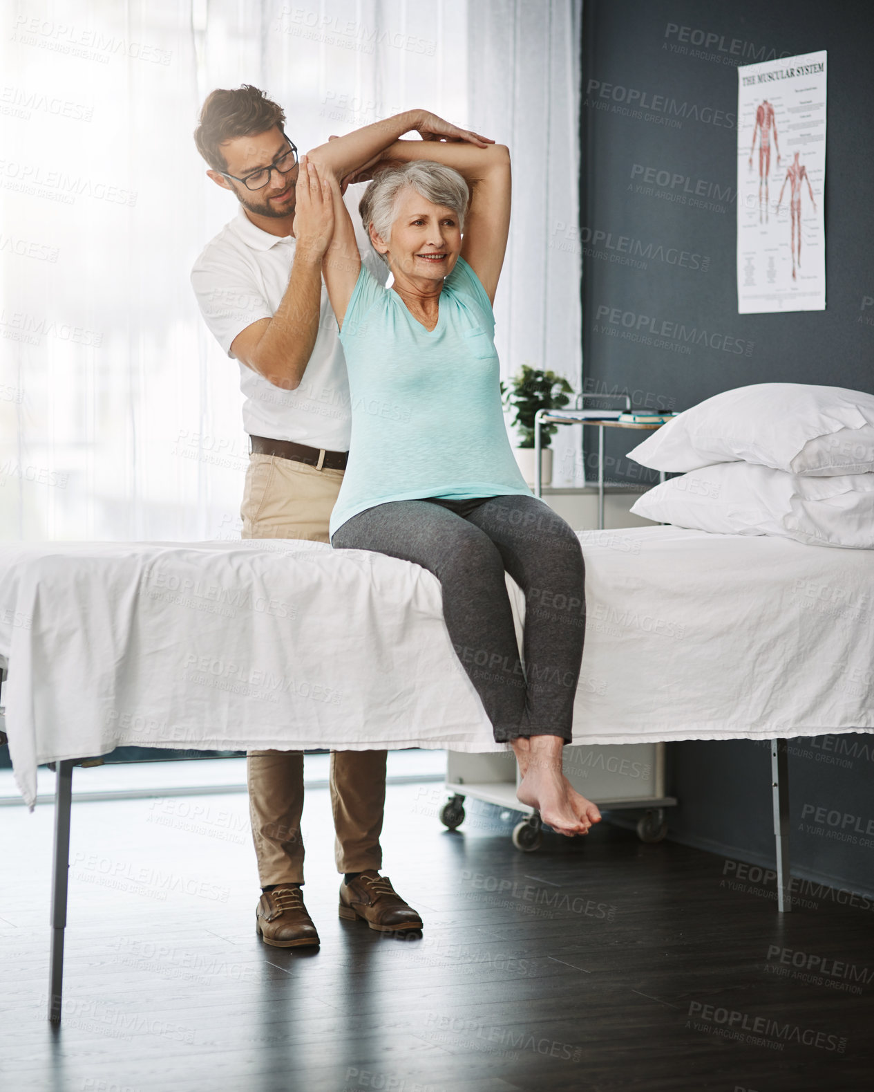 Buy stock photo Full length shot of a young male physiotherapist working with a senior female patient