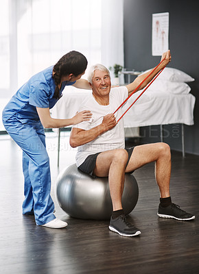 Buy stock photo Full length shot of a young female physiotherapist working with a senior male patient