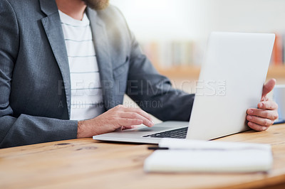 Buy stock photo Cropped shot of an unrecognizable businessman working on his laptop while sitting in the home office
