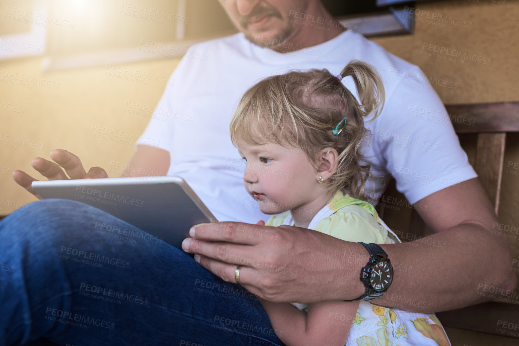Buy stock photo Shot of a father and his little daughter using a digital tablet together outdoors