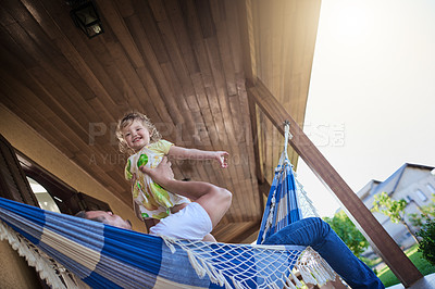 Buy stock photo Dad, girl and happy with play, hammock and bonding in backyard with love, plane and low angle in spring. Father, daughter and child with lift game, smile and airplane on patio with sunshine in Spain