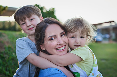 Buy stock photo Portrait of a mother bonding with her two little children outdoors