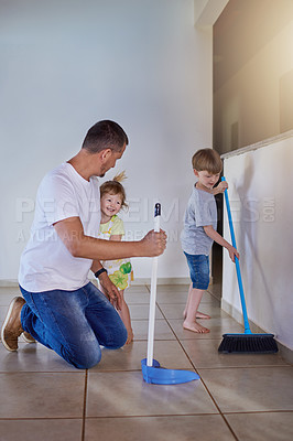 Buy stock photo Cleaning, dad and children with broom, home and sweeping for hygiene, teaching and together for teamwork. Tidy, growth and development of kids with father, learning and prevention of dirt and house