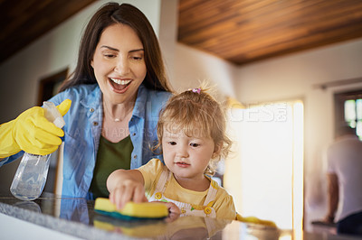 Buy stock photo Mother, child and cleaning table with spray in home for helping hand, teaching hygiene and bonding. Family, woman and girl with disinfectant to wipe surface in house for bacteria and chores support