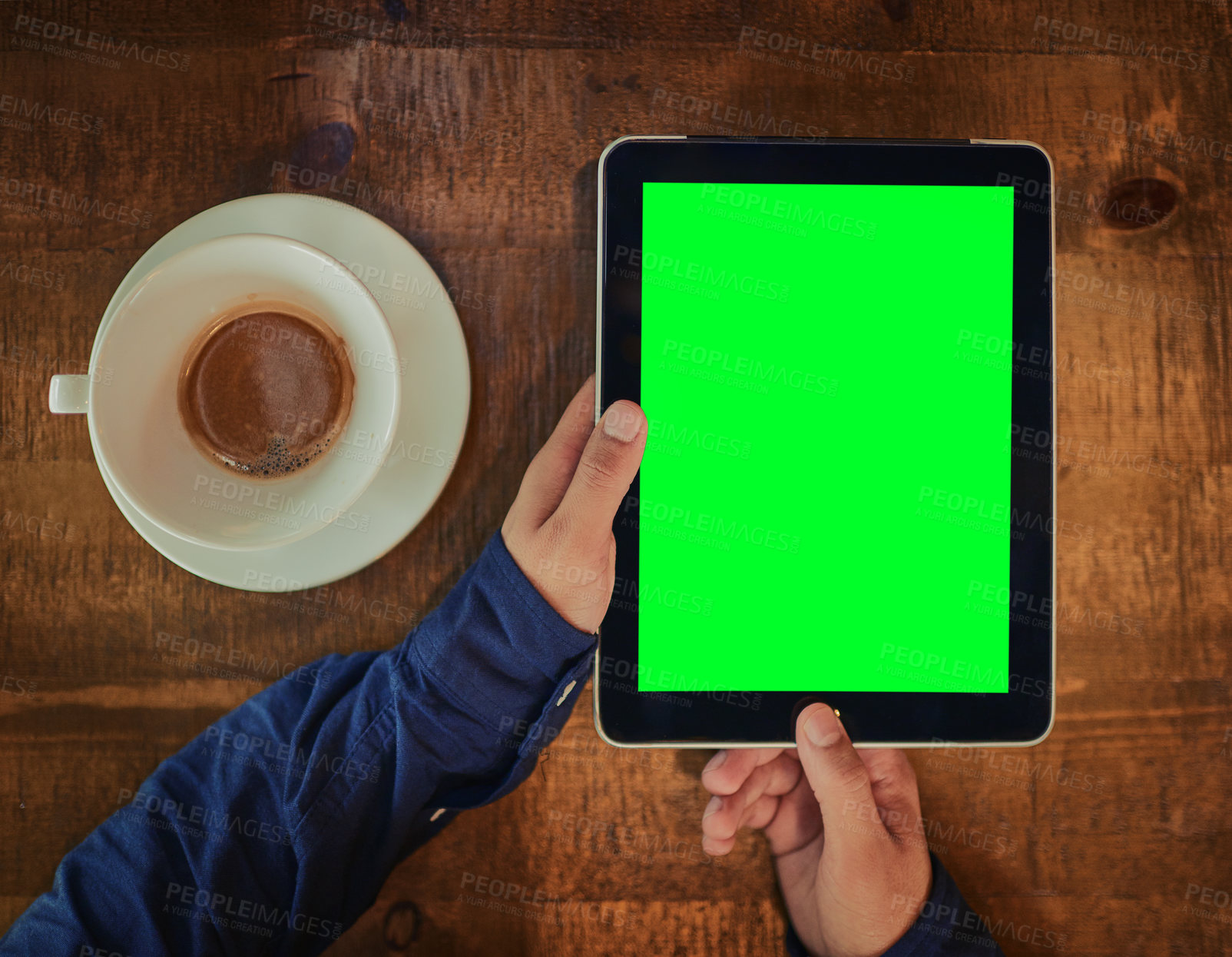 Buy stock photo High angle shot of an unrecognizable man using a digital tablet with a green screen in a cafe