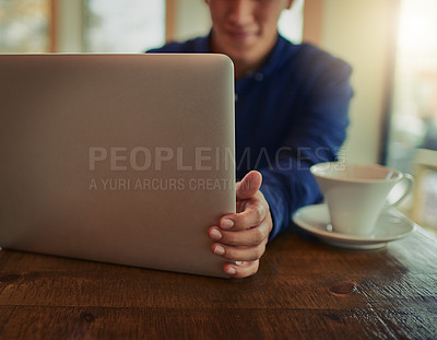 Buy stock photo Cropped shot of a man using a laptop in a cafe