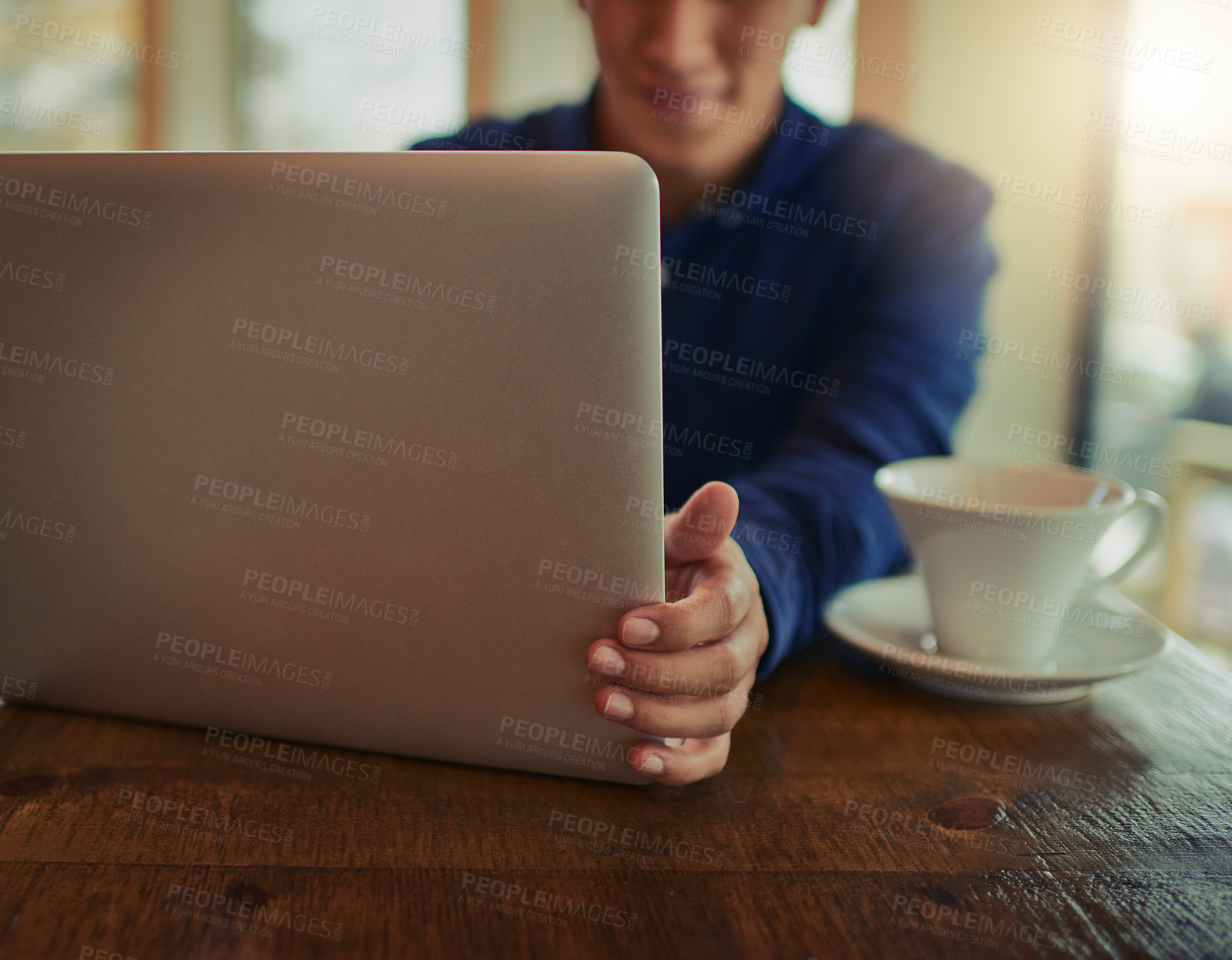 Buy stock photo Cropped shot of a man using a laptop in a cafe